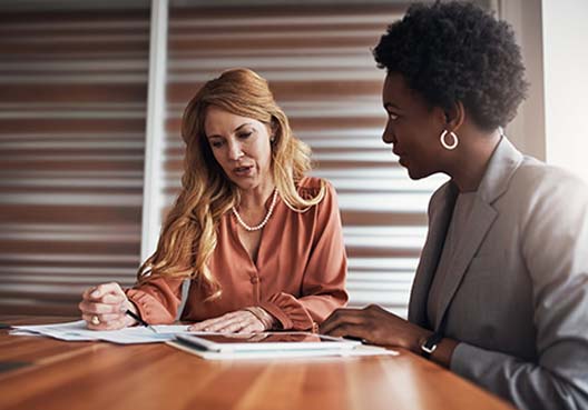 Two businesswomen talking to each other