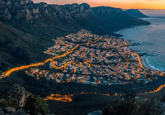 A coastal South African city with illuminated streets, symbolising infrastructure and long-term property investment.